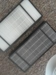 clean HEPA filter next to a used filter
